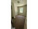 A cozy bedroom featuring neutral walls, a closet, and a bright window providing natural light at 1973 Niskey Lake Sw Rd, Atlanta, GA 30331