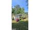 This charming home boasts a brick chimney, welcoming porch, and colorful landscaping against a lush, green lawn at 1973 Niskey Lake Sw Rd, Atlanta, GA 30331