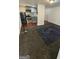 A carpeted basement room featuring an adjacent kitchenette with stainless steel appliances at 1973 Niskey Lake Sw Rd, Atlanta, GA 30331
