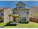Back exterior of home and covered patio with yard at 3733 Upland Dr, Mcdonough, GA 30253