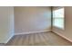 Neutral bedroom with neutral walls, plush carpet, and a large window offering natural light at 3733 Upland Dr, Mcdonough, GA 30253