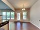Bright dining room with wood floors, a modern chandelier, and access to the backyard at 3733 Upland Dr, Mcdonough, GA 30253