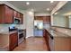 Modern kitchen featuring stainless steel appliances, granite countertops, and beautiful wood flooring at 3733 Upland Dr, Mcdonough, GA 30253