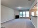Spacious living room featuring plush carpet, a cozy fireplace, and large windows for natural light at 3733 Upland Dr, Mcdonough, GA 30253