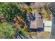 Aerial view showcasing the home's layout, roof, and surrounding landscape at 5284 Silver Creek Sw Dr, Lilburn, GA 30047