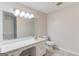 Bright bathroom with a large mirror, a single sink, and a toilet at 5284 Silver Creek Sw Dr, Lilburn, GA 30047