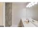 Bright bathroom with a shower and single sink at 5284 Silver Creek Sw Dr, Lilburn, GA 30047