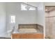 Bathroom featuring a large tub with tile surround and walk-in shower with tile at 5284 Silver Creek Sw Dr, Lilburn, GA 30047