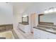 Bright bathroom with double vanity, granite countertop, and large soaking tub at 5284 Silver Creek Sw Dr, Lilburn, GA 30047