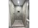 Modern bathroom shower with gray tile and shower head at 5284 Silver Creek Sw Dr, Lilburn, GA 30047