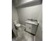 Bathroom featuring a modern vanity with granite countertop and new tiled floors at 5284 Silver Creek Sw Dr, Lilburn, GA 30047