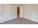 Bedroom with carpet flooring and views to the living room with fireplace at 5284 Silver Creek Sw Dr, Lilburn, GA 30047