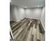 Spacious bedroom with new gray paint, modern laminate floors, and updated lighting at 5284 Silver Creek Sw Dr, Lilburn, GA 30047