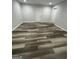 Spacious bedroom with new gray paint, modern laminate floors, and updated lighting at 5284 Silver Creek Sw Dr, Lilburn, GA 30047