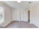 Bedroom featuring neutral walls, carpet, and a closet with an open door at 5284 Silver Creek Sw Dr, Lilburn, GA 30047