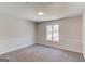Neutral bedroom with a window that looks out at a house and yard at 5284 Silver Creek Sw Dr, Lilburn, GA 30047