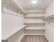 Spacious walk-in closet with built-in white shelving at 5284 Silver Creek Sw Dr, Lilburn, GA 30047