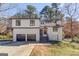 Charming two-story home with a two-car garage, neutral color scheme, and attractive landscaping at 5284 Silver Creek Sw Dr, Lilburn, GA 30047