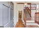 Inviting foyer showcases hardwood floors, a staircase, and a view into a stylish living area at 5284 Silver Creek Sw Dr, Lilburn, GA 30047