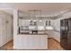 Bright kitchen with white cabinets, modern appliances, and pendant lighting at 5284 Silver Creek Sw Dr, Lilburn, GA 30047