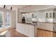 Stylish kitchen with white cabinets, a functional island, and an adjacent sunroom with ample natural light at 5284 Silver Creek Sw Dr, Lilburn, GA 30047