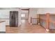 Open concept living space with a stainless steel refrigerator and wood floors at 5284 Silver Creek Sw Dr, Lilburn, GA 30047
