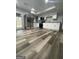Modern kitchen with stainless steel appliances, white cabinetry, and updated flooring at 5284 Silver Creek Sw Dr, Lilburn, GA 30047