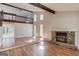 Spacious living room features hardwood floors, a stone fireplace, and natural light from tall windows at 5284 Silver Creek Sw Dr, Lilburn, GA 30047