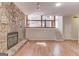 Living room with stone fireplace, access to second story and staircase at 5284 Silver Creek Sw Dr, Lilburn, GA 30047