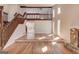 Open-concept living room features hardwood floors, a stone fireplace, and access to the second floor at 5284 Silver Creek Sw Dr, Lilburn, GA 30047