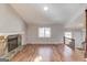 Cozy living room with a stone fireplace, hardwood floors, and a staircase leading to the upper level at 5284 Silver Creek Sw Dr, Lilburn, GA 30047