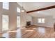 Bright living room with cathedral ceiling features hardwood floors, a stone fireplace, and multiple windows at 5284 Silver Creek Sw Dr, Lilburn, GA 30047