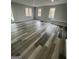Spacious living room with gray walls, recessed lighting, multiple windows and beautiful hardwood floors at 5284 Silver Creek Sw Dr, Lilburn, GA 30047