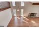 Open-concept living room featuring hardwood floors, fireplace, and multiple windows for ample natural light at 5284 Silver Creek Sw Dr, Lilburn, GA 30047