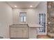 Wet bar with granite countertop adjacent to an open living room space at 5284 Silver Creek Sw Dr, Lilburn, GA 30047