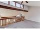 Carpeted loft with natural wood trim, overlooking the living room and foyer areas at 5284 Silver Creek Sw Dr, Lilburn, GA 30047