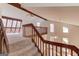 Open staircase with carpet and wooden railing, leading to a bright, sunlit second floor loft area at 5284 Silver Creek Sw Dr, Lilburn, GA 30047