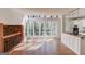 Bright sunroom adjacent to the kitchen features walls of windows and hardwood floors at 5284 Silver Creek Sw Dr, Lilburn, GA 30047