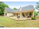 Exterior of home with backyard, fire pit, outdoor furniture, and a covered patio at 563 Deadwood Trl, Locust Grove, GA 30248