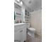 Bathroom with a white vanity, wall cabinet, shower curtain, and a modern designed toilet at 563 Deadwood Trl, Locust Grove, GA 30248