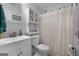 Bathroom featuring a white vanity, wall cabinet, shower curtain, and decor at 563 Deadwood Trl, Locust Grove, GA 30248
