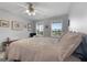 Cozy bedroom features soft lighting, two large windows, and a comfortable bed at 563 Deadwood Trl, Locust Grove, GA 30248