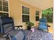 Covered back patio with relaxing furniture and space at 563 Deadwood Trl, Locust Grove, GA 30248