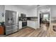 Updated kitchen with stainless steel appliances, white cabinetry, and mosaic backsplash at 563 Deadwood Trl, Locust Grove, GA 30248