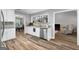 Bright kitchen featuring white cabinets, granite countertops, and stainless steel dishwasher at 563 Deadwood Trl, Locust Grove, GA 30248