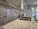 Close-up of kitchen sink with granite countertop and mosaic tile backsplash at 563 Deadwood Trl, Locust Grove, GA 30248