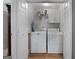 Well-maintained laundry room with washer, dryer, storage shelves, and white painted doors at 563 Deadwood Trl, Locust Grove, GA 30248