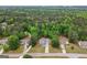 Aerial view of a lovely single-Gathering home surrounded by mature trees and well-maintained lawns in a quiet neighborhood at 563 Deadwood Trl, Locust Grove, GA 30248