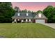Charming single-story home featuring a brick facade, inviting porch, and attached two-car garage at 563 Deadwood Trl, Locust Grove, GA 30248