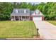 Charming home featuring a welcoming front porch, attached garage, and a well-maintained lawn in a suburban setting at 563 Deadwood Trl, Locust Grove, GA 30248
